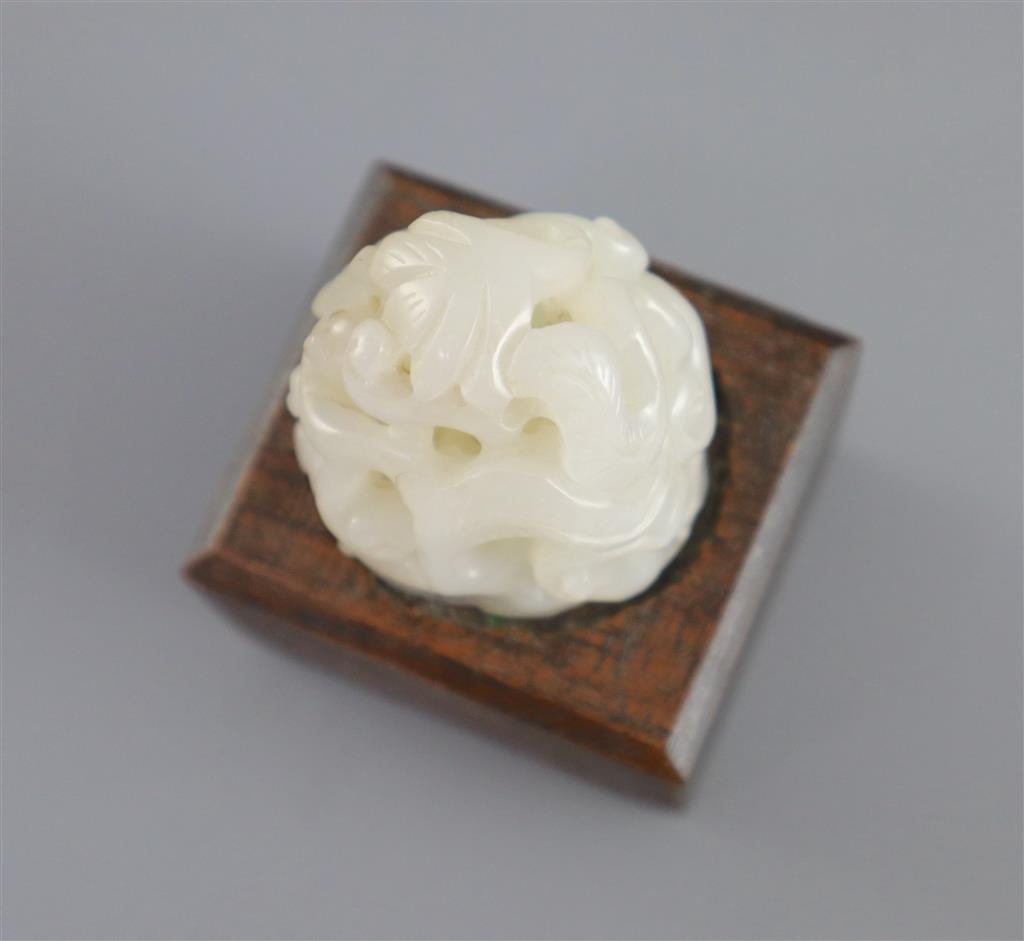 A Chinese white jade hat finial, 3.8cm high, later wood stand